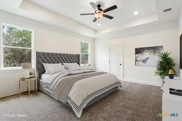 a bedroom with a bed and a potted plant on the dresser