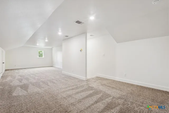 an empty room with a empty space and windows