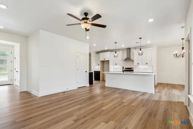 a view of a kitchen with wooden floor and a window