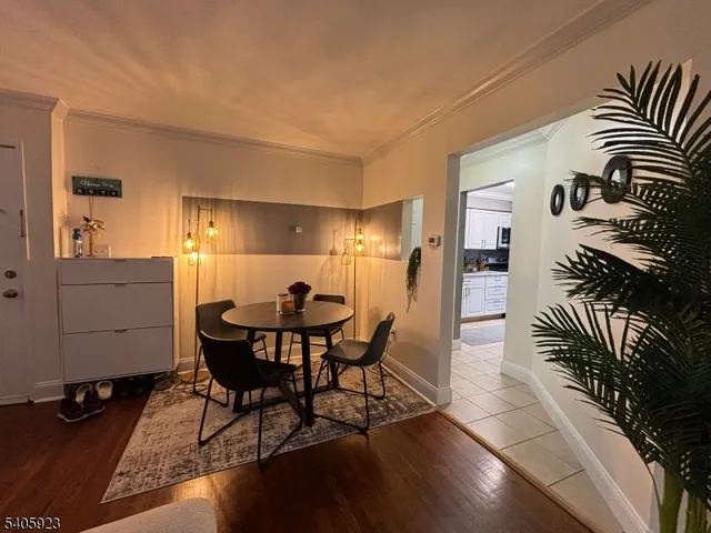 a dining room with furniture and wooden floor