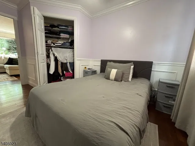 a bed room with a bed and a view of closet