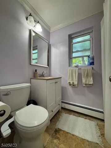a bathroom with a toilet a sink and a window