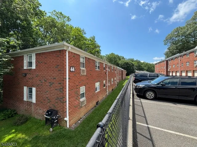 a view of a car in front of a house with a yard