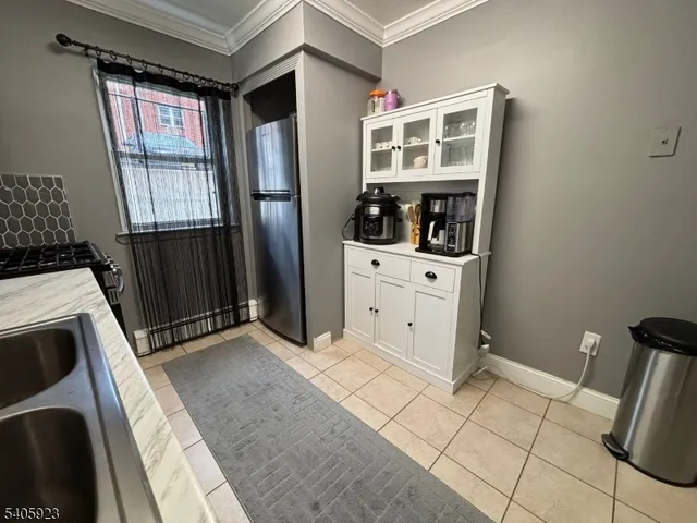 a kitchen with a refrigerator and a stove top oven