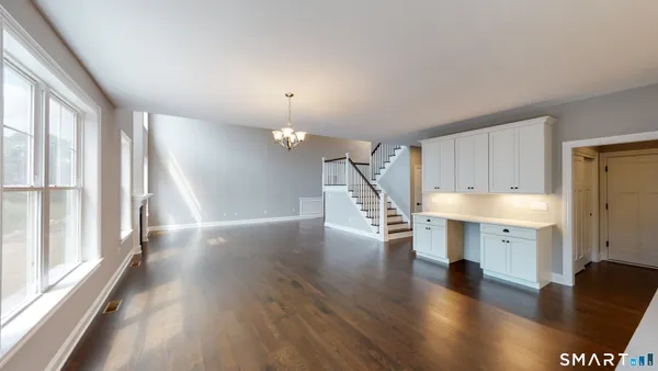 wooden floor in an empty room with a window and wooden floor