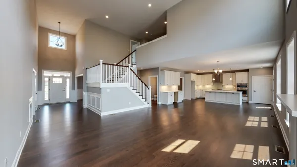 a view of a living room and kitchen with furniture and window