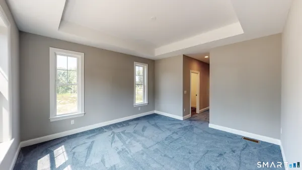 an empty room with windows and closet