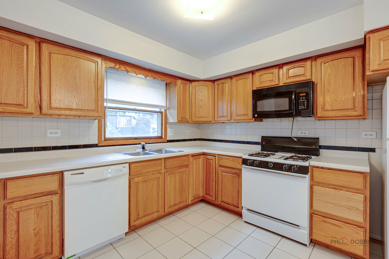 103 Quail Run Lake In The Hills, IL 60156 - Photo 3 of 25 a kitchen with granite countertop cabinets stainless steel appliances and a sink