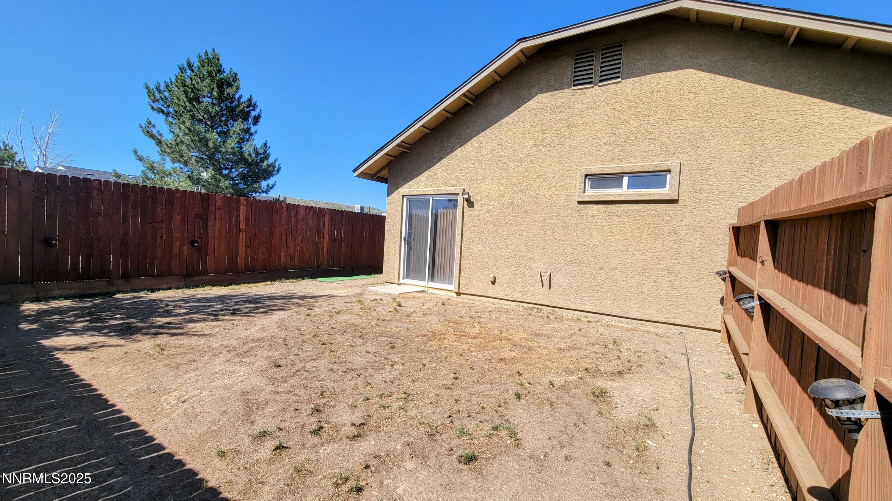 1390 Copper Leaf Drive Reno, NV 89506 - Photo 18 of 18 a view of a house with a wooden fence