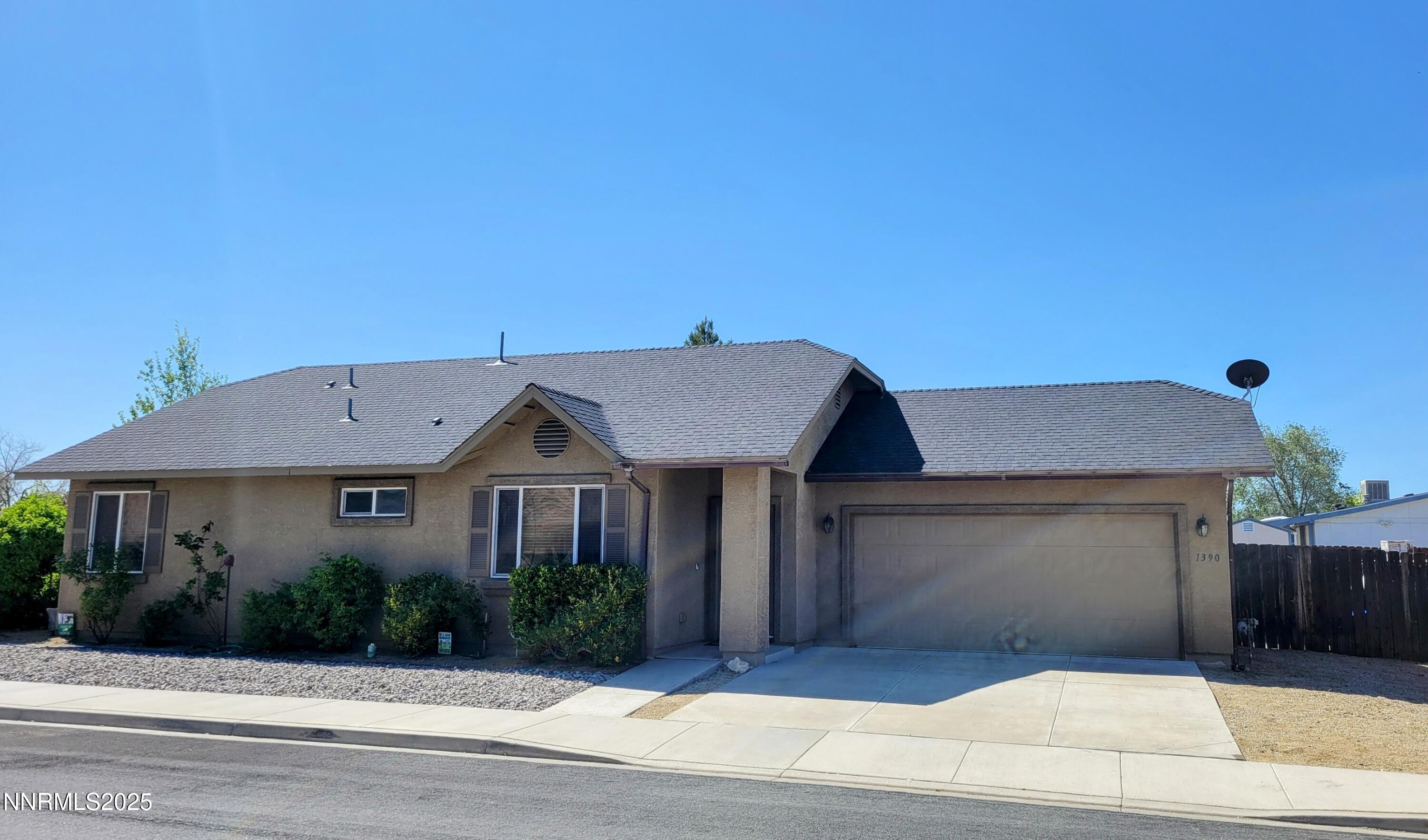 1390 Copper Leaf Drive Reno, NV 89506 - Photo 3 of 18 a front view of a house with a garden