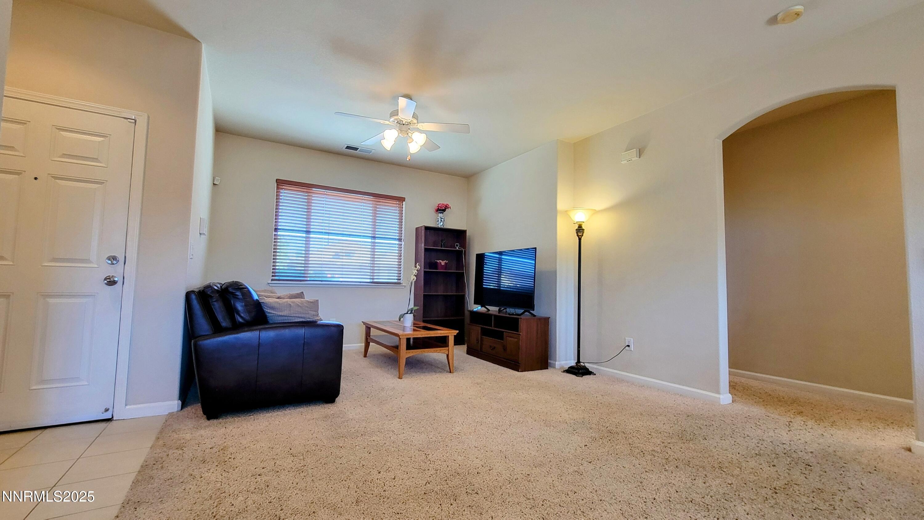 1390 Copper Leaf Drive Reno, NV 89506 - Photo 6 of 18 a living room with furniture and a flat screen tv
