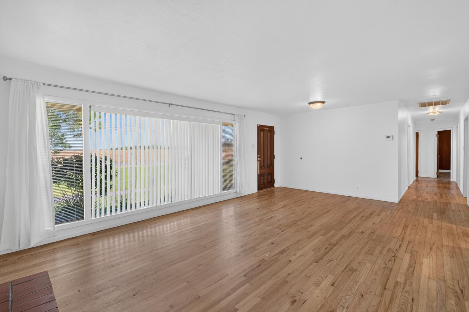 10700 Calvine Road Elk Grove, CA 95830 - Photo 13 of 73 a view of empty room with wooden floor and fan