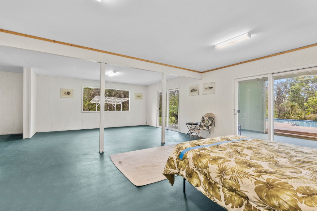 16-2103 Opeapea Road Mountain View, HI 96771 - Photo 16 of 30 a bed sitting in a spacious bedroom next to a window