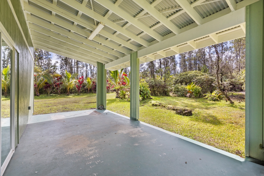 16-2103 Opeapea Road Mountain View, HI 96771 - Photo 21 of 30 a view of a room with wooden floor and door