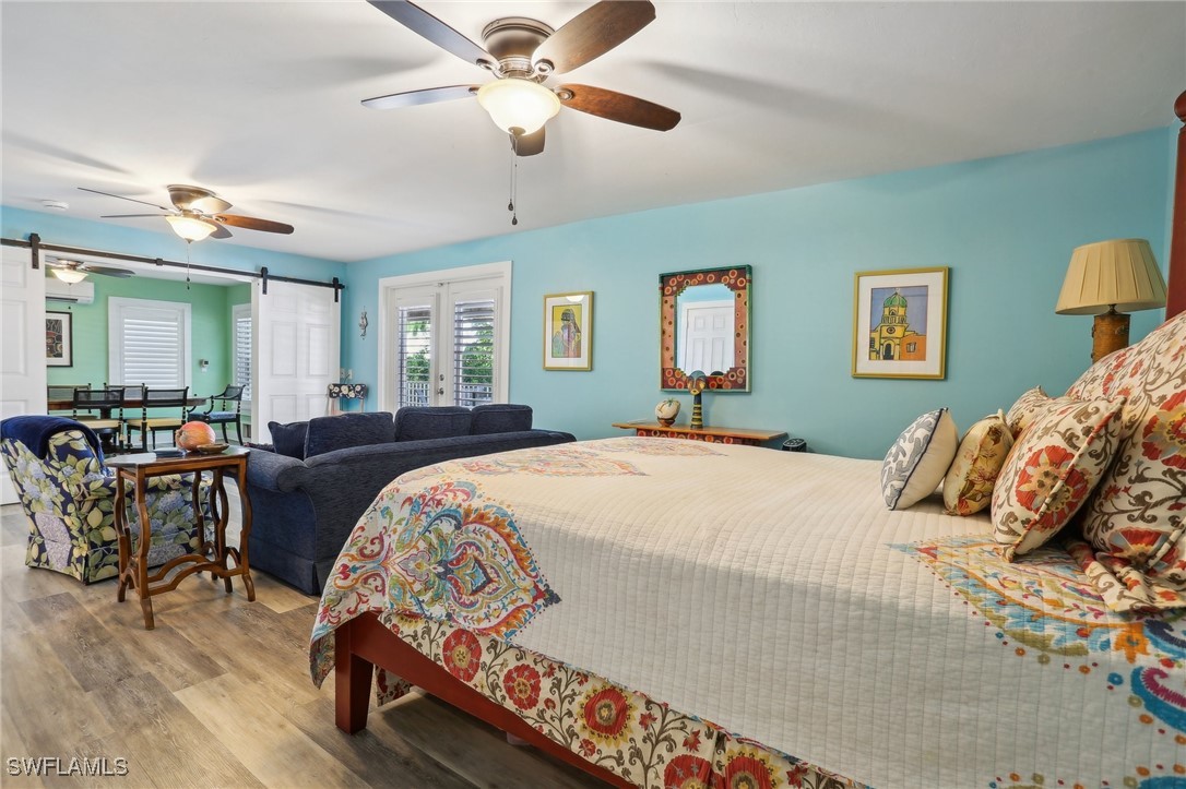 8335 Main Street Bokeelia, FL 33922 - Photo 42 of 47 a bedroom with a large bed and a chandelier