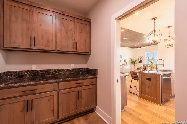 a kitchen with stainless steel appliances granite countertop a refrigerator and a stove top oven
