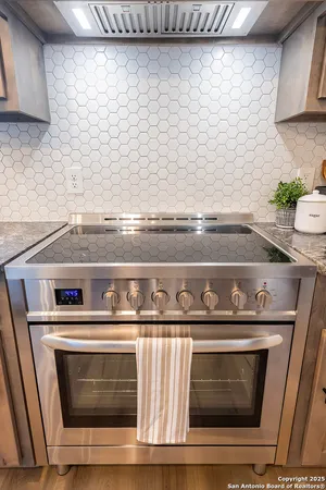 a stove top oven sitting inside of a kitchen
