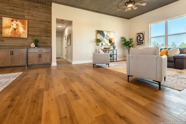 a living room with furniture and wooden floor