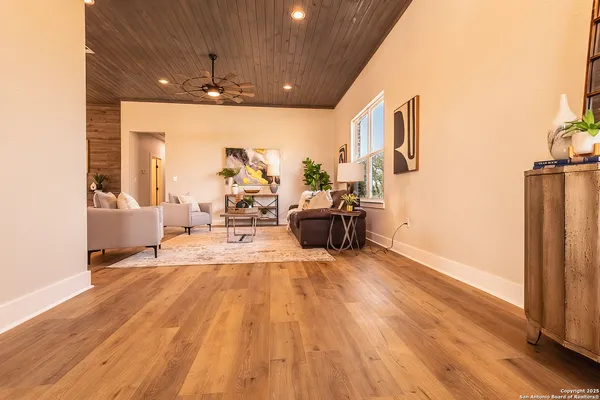 a view of a living room hardwood floor and a kitchen