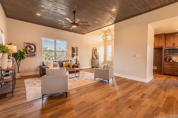a living room with furniture and a chandelier