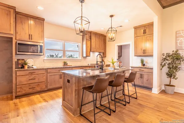 a kitchen with a table chairs stove and cabinets