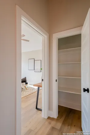 a view of a room that has a bed and a window in it