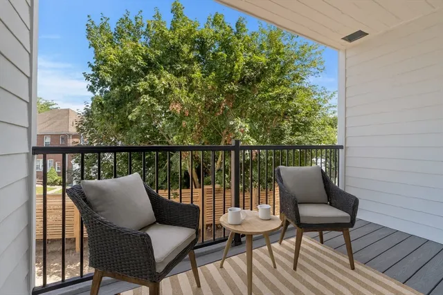 a view of a chair and table on the deck