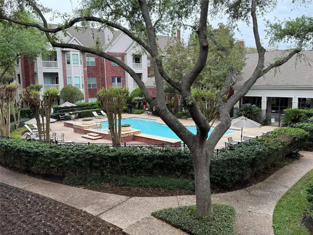a tree in front of a white house