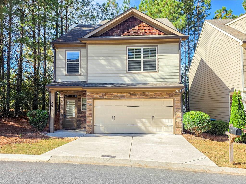 601 Summit Point Canton, GA 30114 - Photo 1 of 1 a front view of a house with a yard and garage