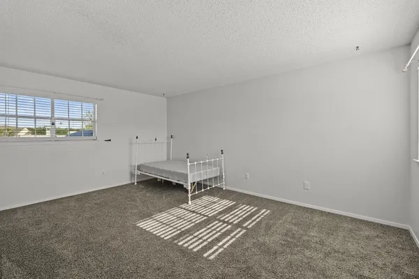 an empty room with closet and mirror