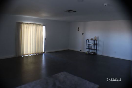 425 Veada Avenue Ridgecrest, CA 93555 - Photo 35 of 35 an empty room with wooden floor and windows