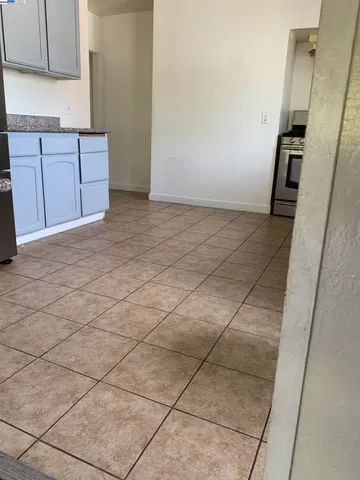 a view of a kitchen with wooden cabinets