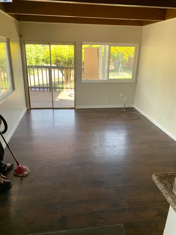 a view of a room with wooden floor and windows