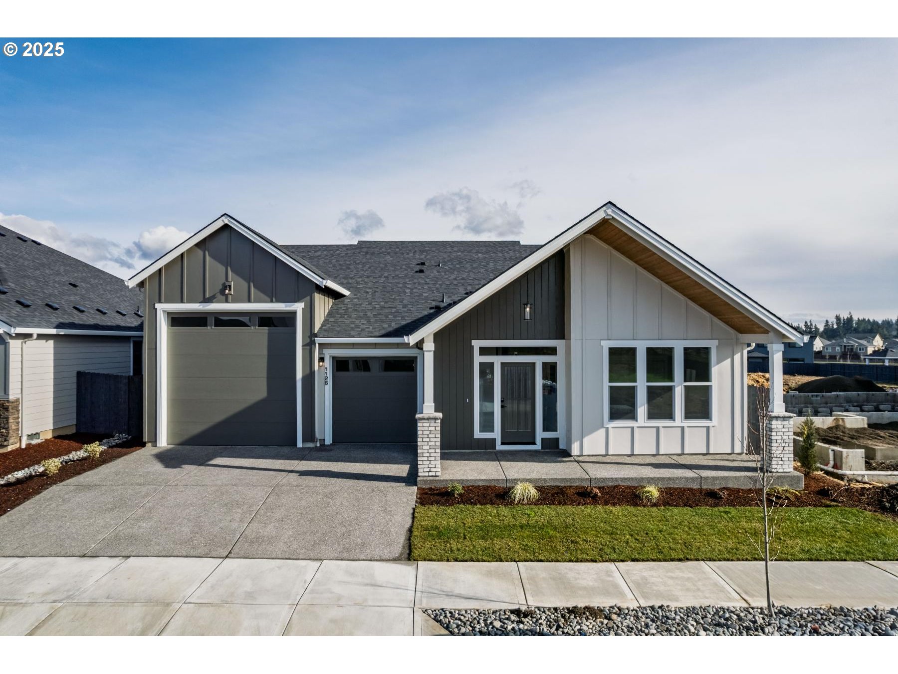 1126 South 46th Place Ridgefield, WA 98642 - Photo 1 of 43 a front view of a house with a yard and garage
