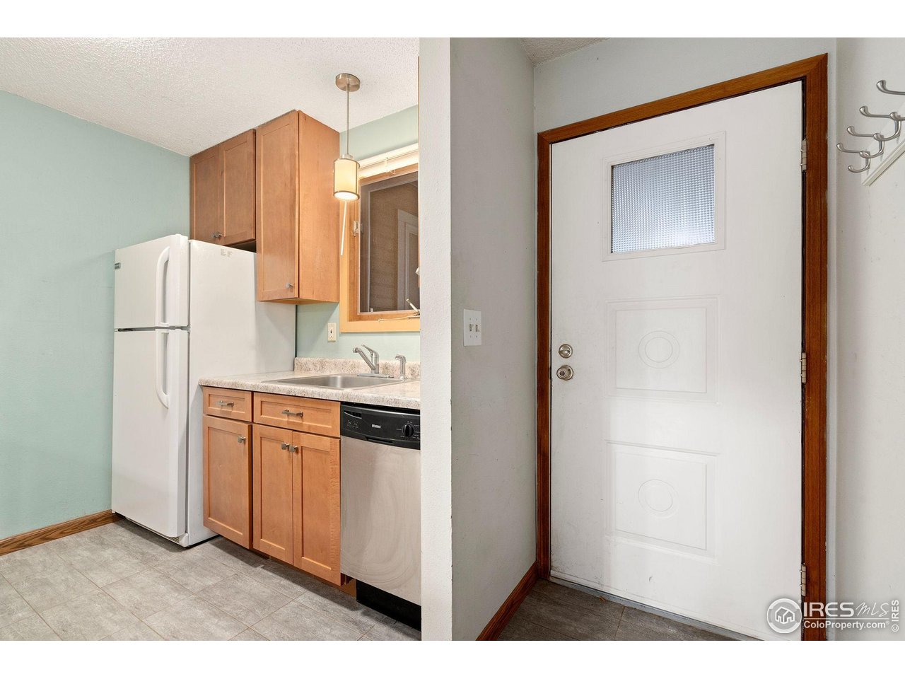1213 West Swallow Road, Unit 213 Fort Collins, CO 80526 - Photo 12 of 24 a kitchen with cabinets a refrigerator and a stove