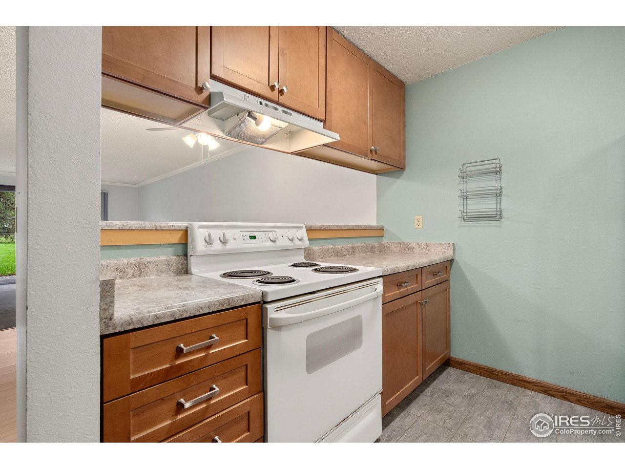 1213 West Swallow Road, Unit 213 Fort Collins, CO 80526 - Photo 13 of 24 a kitchen with stainless steel appliances granite countertop a sink and a stove