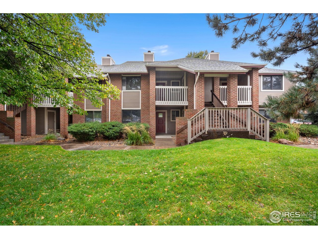 1213 West Swallow Road, Unit 213 Fort Collins, CO 80526 - Photo 2 of 24 a front view of a house with a yard