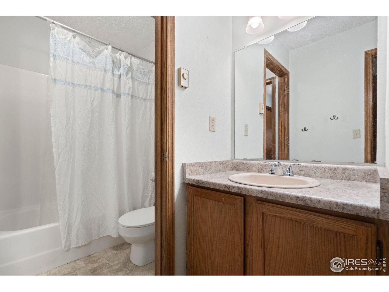 1213 West Swallow Road, Unit 213 Fort Collins, CO 80526 - Photo 22 of 24 a bathroom with a granite countertop sink toilet and shower