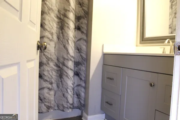 a bathroom with a shower and a sink