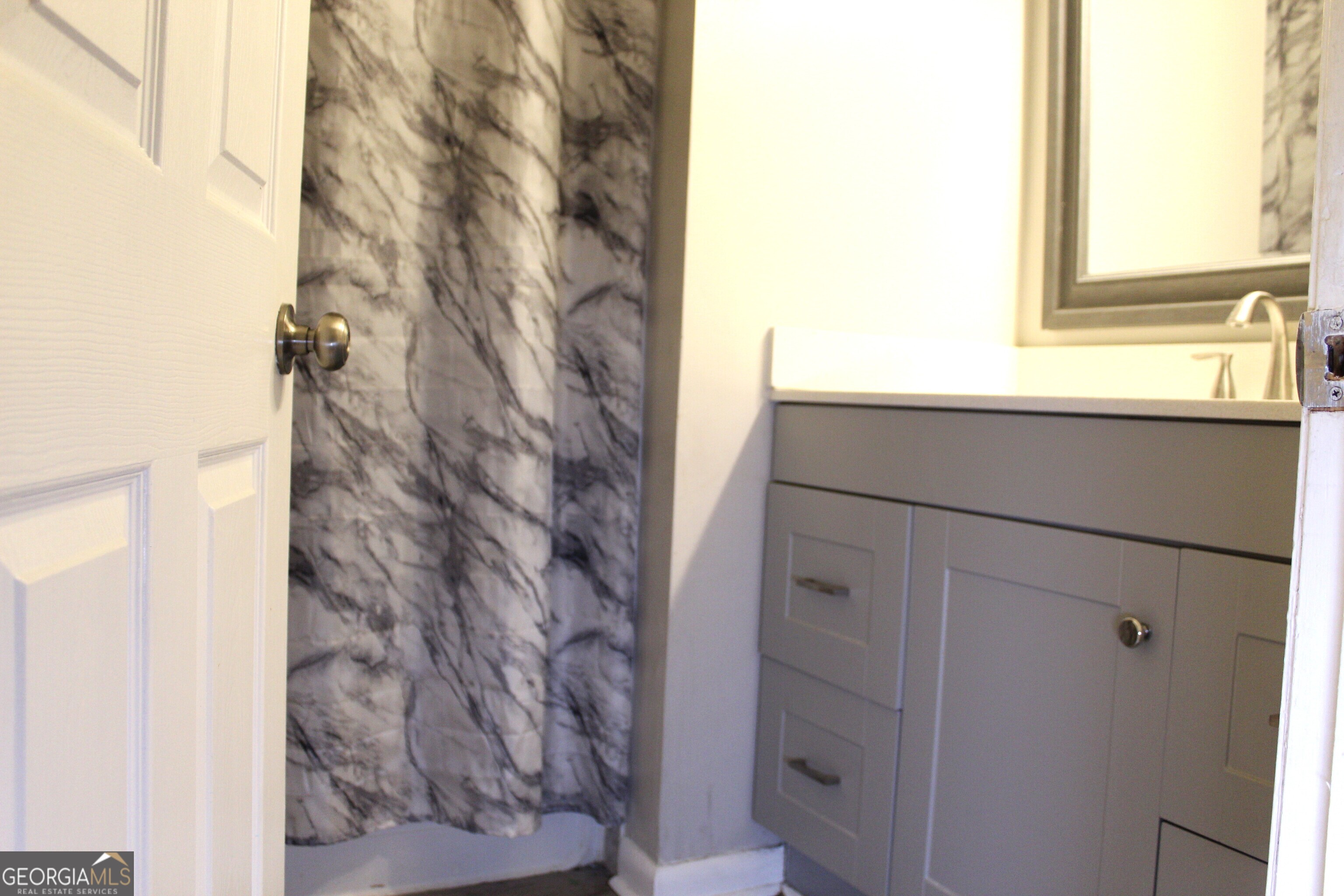 5811 Calico Court Lithonia, GA 30058 - Photo 14 of 14 a bathroom with a shower and a sink