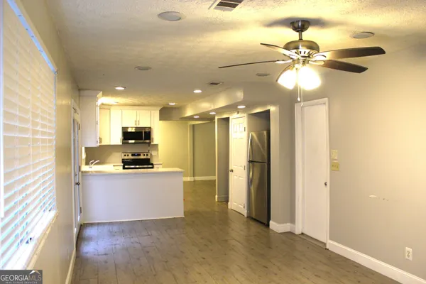 a kitchen with stainless steel appliances a refrigerator sink and stove