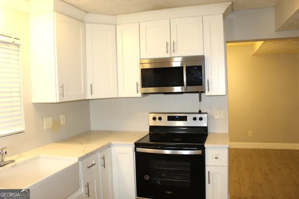 a kitchen with a stove and a microwave