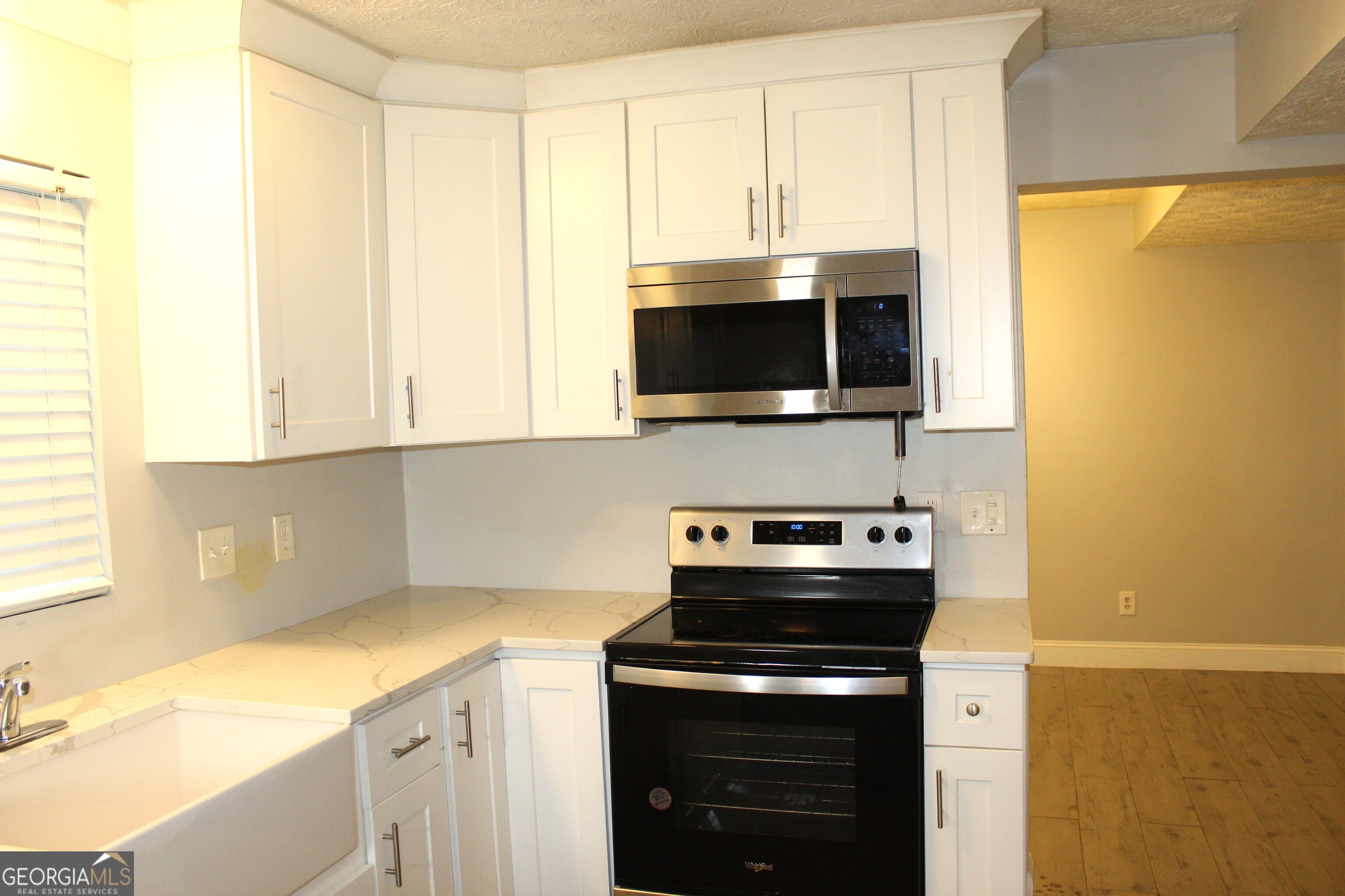 5811 Calico Court Lithonia, GA 30058 - Photo 3 of 14 a kitchen with a stove and a microwave