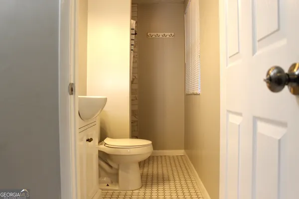 a bathroom with a toilet and a mirror