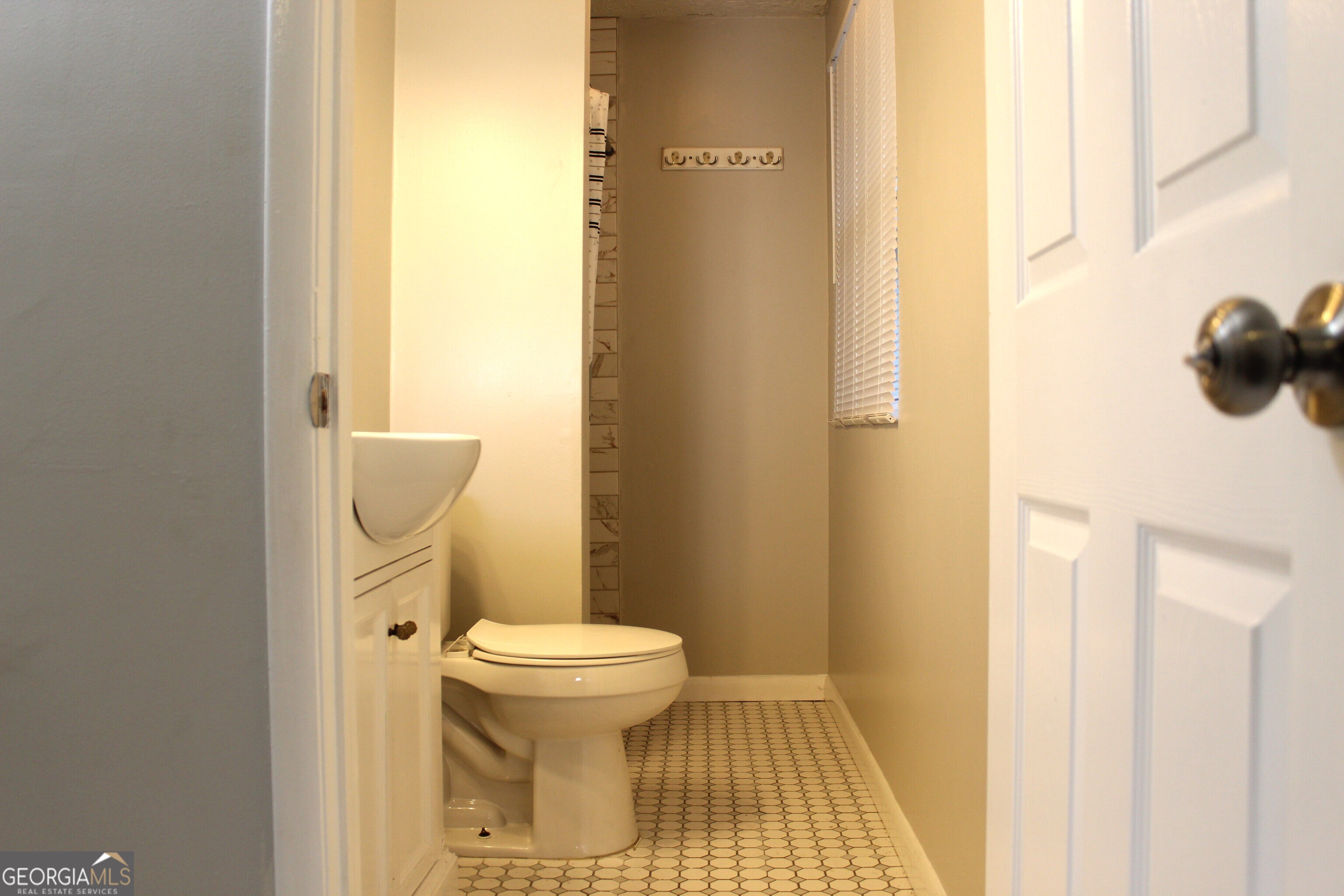 5811 Calico Court Lithonia, GA 30058 - Photo 10 of 14 a bathroom with a toilet and a mirror