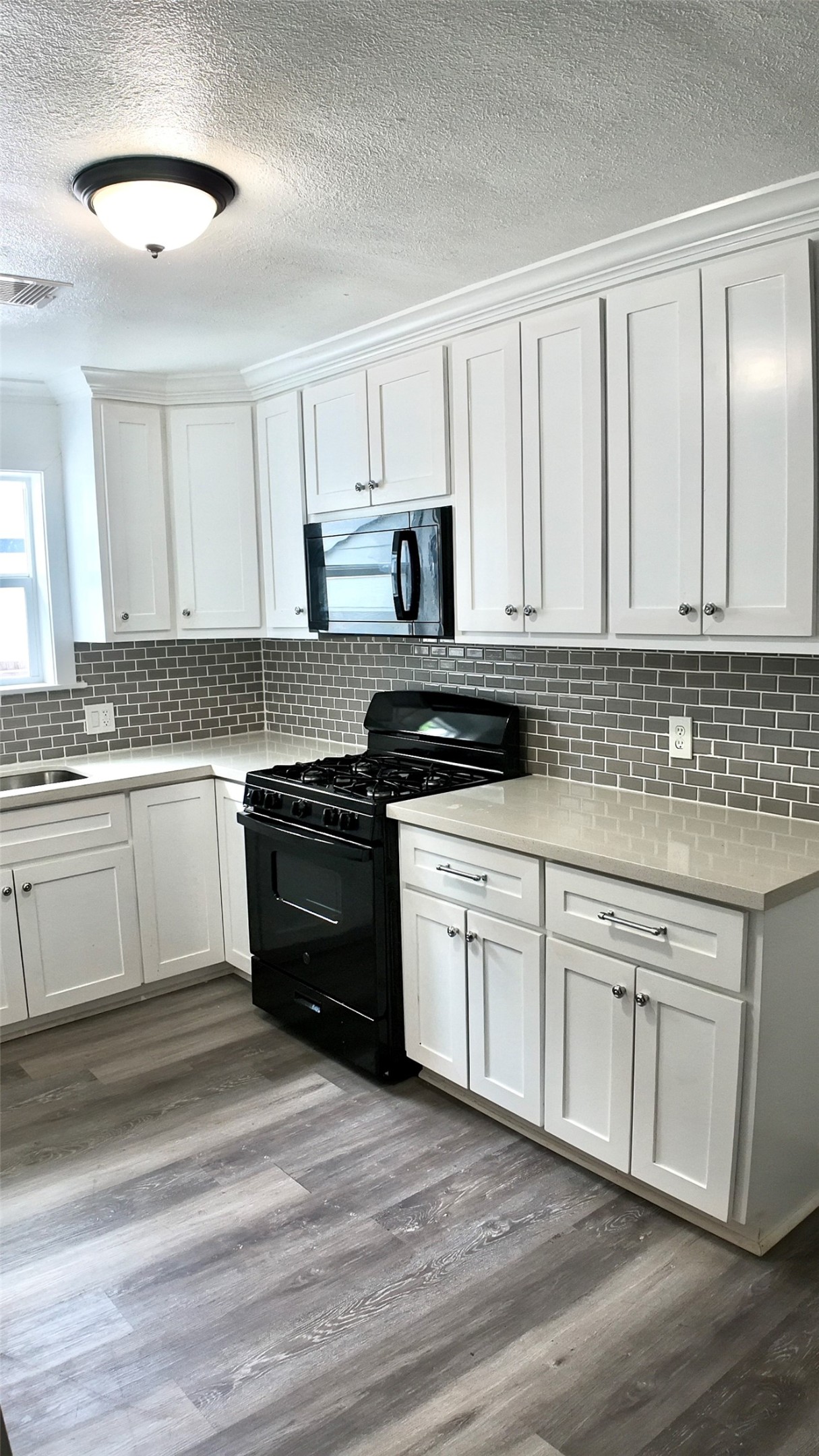 3618 Mainer Street Houston, TX 77021 - Photo 10 of 17 a kitchen with granite countertop white cabinets and white appliances