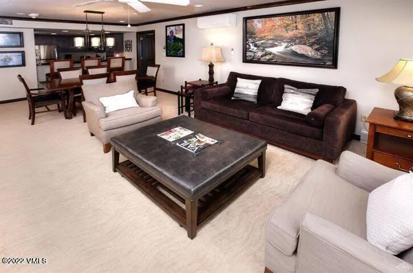 a living room with furniture a rug and a table
