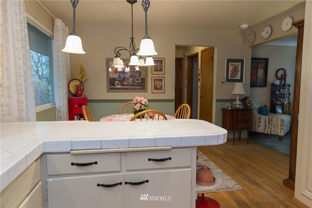 1419 18th Street Everett, WA 98201 - Photo 12 of 21 a room with kitchen island a chandelier and wooden floor