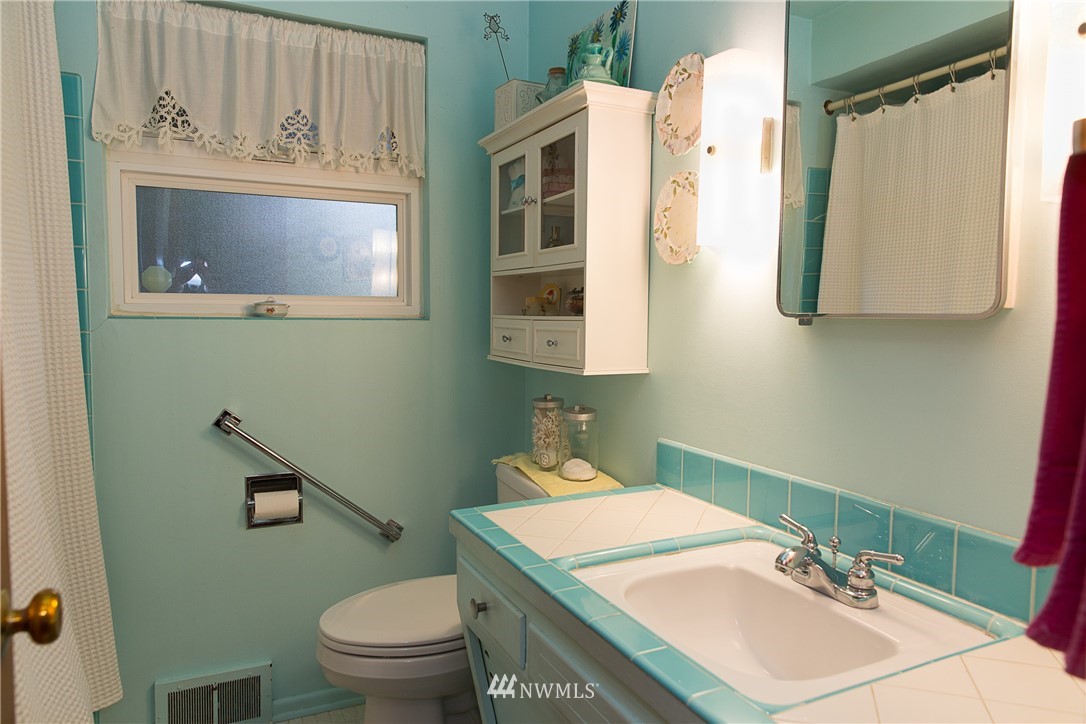 1419 18th Street Everett, WA 98201 - Photo 13 of 21 a bathroom with a sink a mirror and a toilet