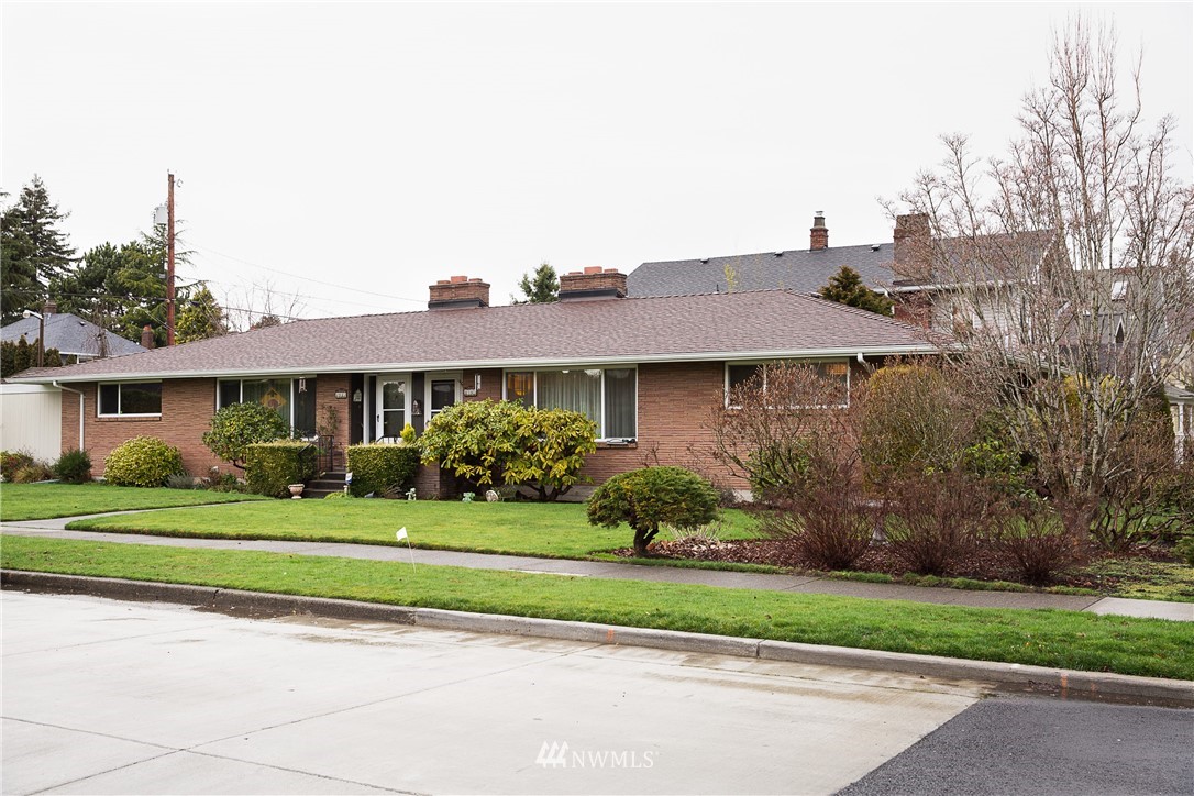 1419 18th Street Everett, WA 98201 - Photo 20 of 21 a front view of a house with a yard and potted plants